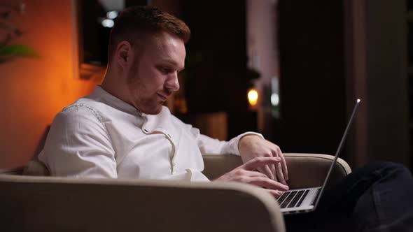 Handsome Bearded Man Using Laptop Working From Home in Internet. 