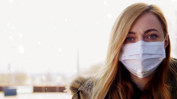 Woman Wearing Protective Medical Mask in Winter