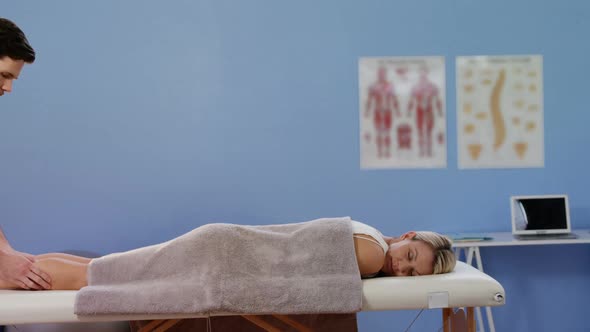 Female patient receiving calf massage form physiotherapist