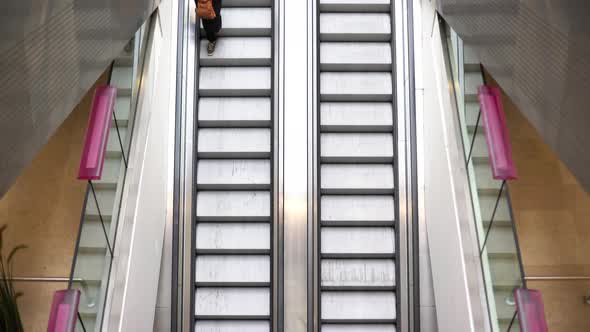 Pedestrians riding escalators