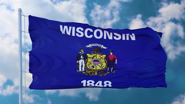 Wisconsin Flag on a Flagpole Waving in the Wind Blue Sky Background