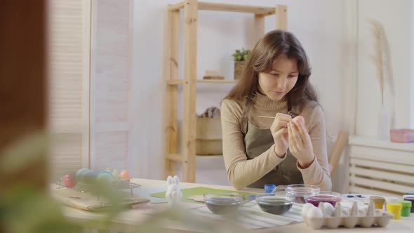 Woman Decorating Easter Egg