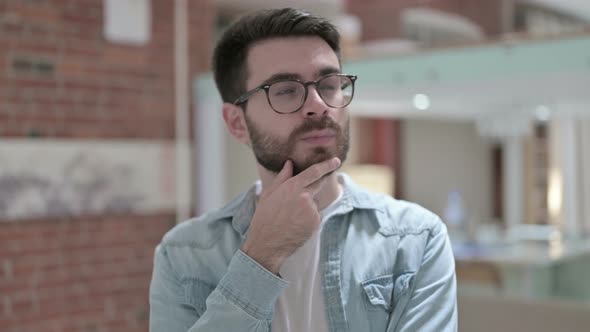 Portrait of Thoughtful Young Male Designer Thinking