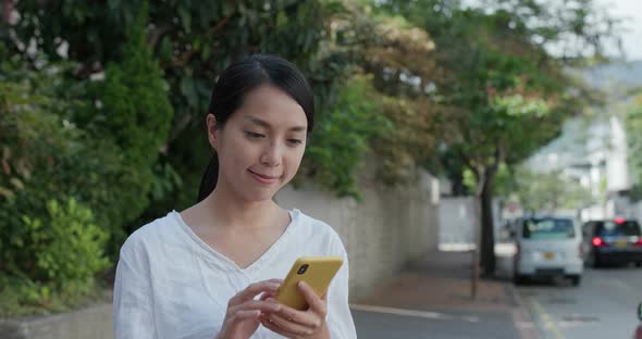 Woman check on mobile phone at outdoor 