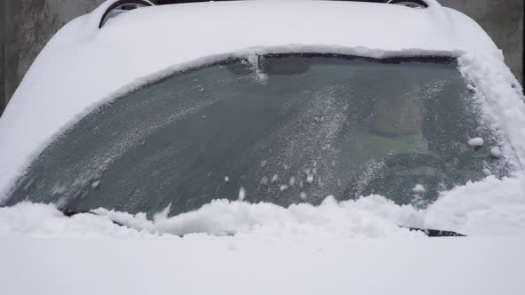 car wipers clean the windshield of snow, the girl starts moving