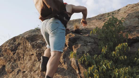 Hiker walking on mountains. Male traveler with traveling bag walking. Businessman in wild nature.