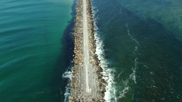 Overhead view from the end of the Gold Coast Seaway panning up toward the beach, highlighting the de