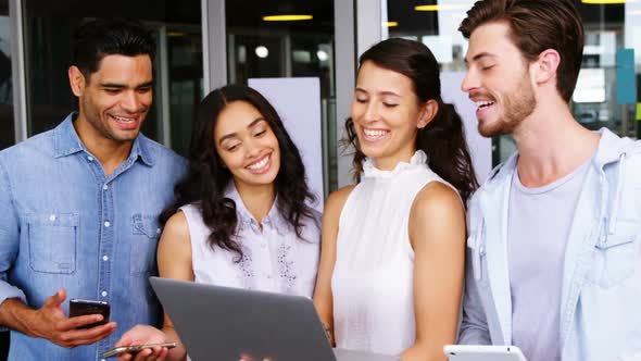 Happy executives using laptop