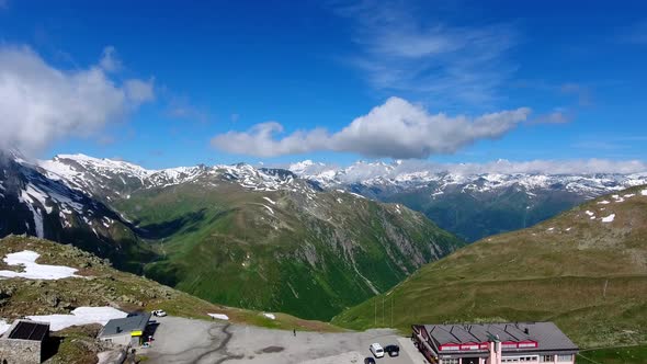 Overflying Nufenenpass in the Swiss AlpsEarly summer with unmelted patches of snow