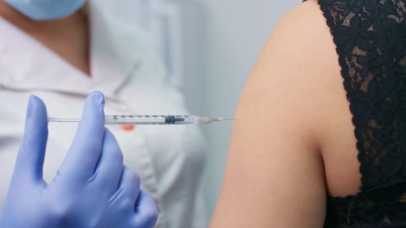 The Doctor Uses a Hypodermic Needle and Syringe To Inject Medication As Treatment