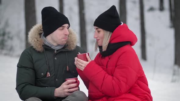 Young Family at Winter Day Drinking Fresh Tea Outdoors