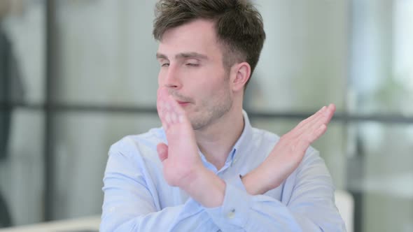 Portrait of No Sign By Young Man By Arms Gesture