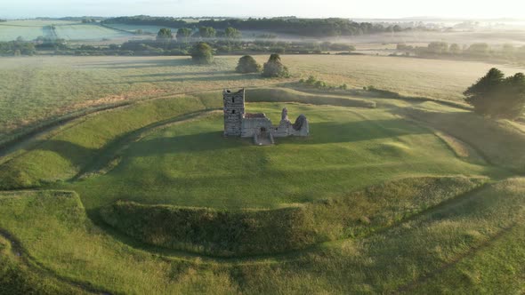 Knowlton Church and Earthworks, Dorset, UK. Sunrise aerial view.