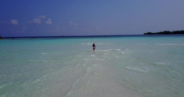 Modern smiling lady on holiday enjoying life at the beach on summer white sand and blue background 4