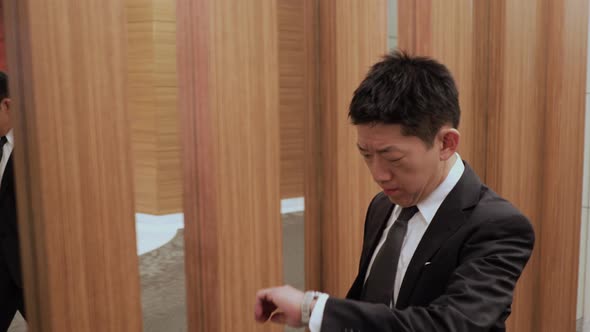 Japanese businessman walking down a hallway