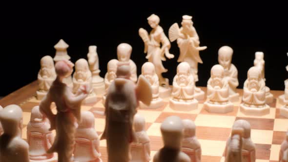 Conceptual Chessboard game, Rotating in a Black Background. Chinese figures