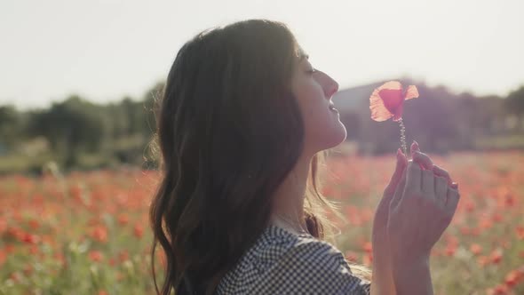 Beautiful Girl Has Fun in Nature Alone with Flowers in Summer