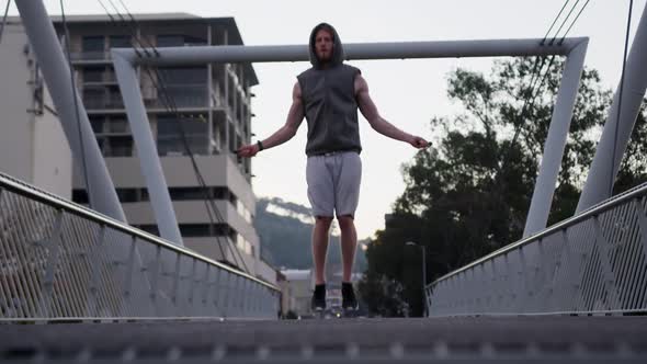 Sporty Caucasian man training on a bridge