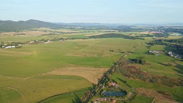 Landscape with Mountains Green Fields and Countryside Village Aerial View