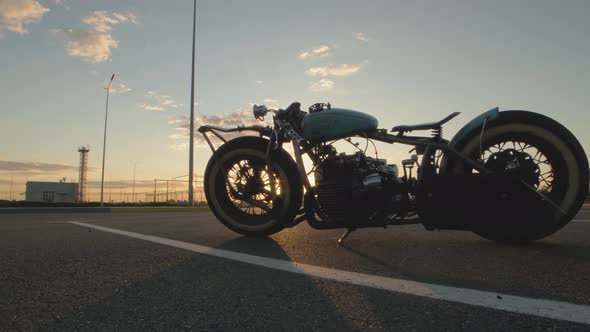 Closeup Dolly Shot of Custom Cafe Racer Motorcycle at Sunset on Street