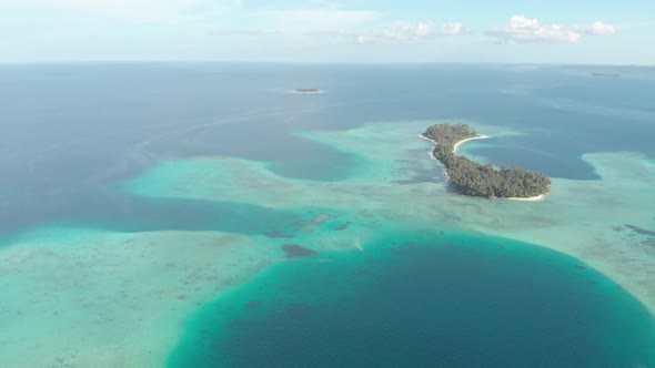 Aerial: flying over exotic tropical island secluded destination away from it all