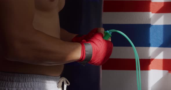 Side view of caucasian man working out in boxing gym