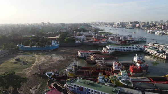 Unofficial shipyard narrowing Buriganga river and causing environmental degradation. Aerial, Banglad