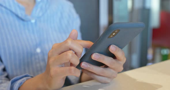 Woman use of mobile phone in restaurant