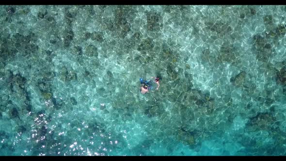 Man and woman in love on paradise lagoon beach break by blue lagoon and white sand background of the