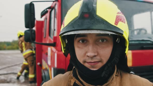 Portrait Shot of the Fireman in Full Uniform Ready for the Rescue. Slow Motion