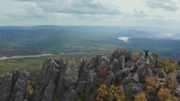 Flying Over Sharp Cliffs with People at the Top