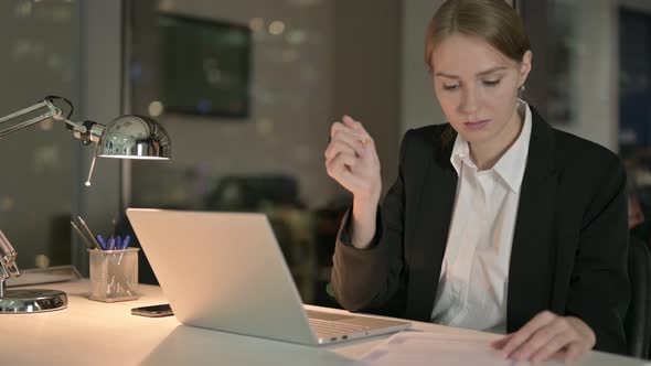 Tired Businesswoman Having Headache on Office Desk at Night 