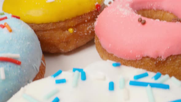 Delicious Multi-colored Donuts on a White Background Smooth Dolly Motion