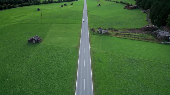 Road in Austria Between Green Fields In an Alpine Village Aerial View