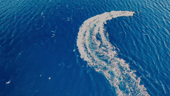 Aerial View of a Motor Boat Towing a Tube. Elounda, Crete, Greece