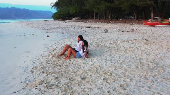 Beautiful women posing on relaxing island beach break by blue ocean and bright sandy background of B