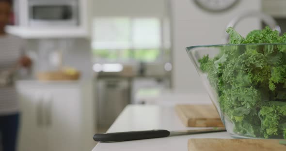 Video of bowl with salad and utensils lying on countertop in kitchen