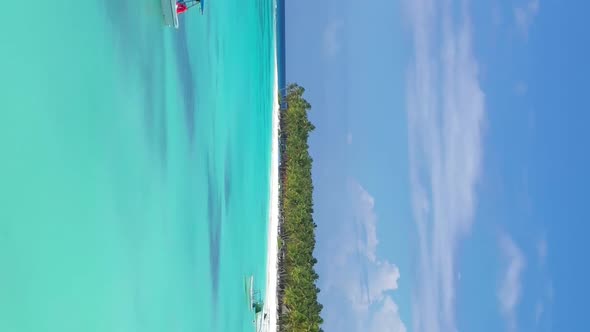 Tropical Island with Coconut Palm Trees and Turquoise Caribbean Sea with Floating Boats