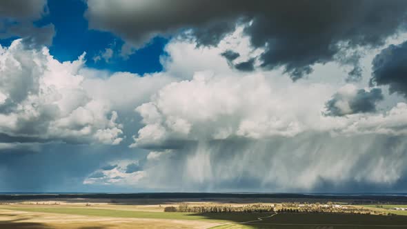 Rain Clouds Rain Sky Above Countryside Rural Field Landscape In Spring Summer Cloudy Day