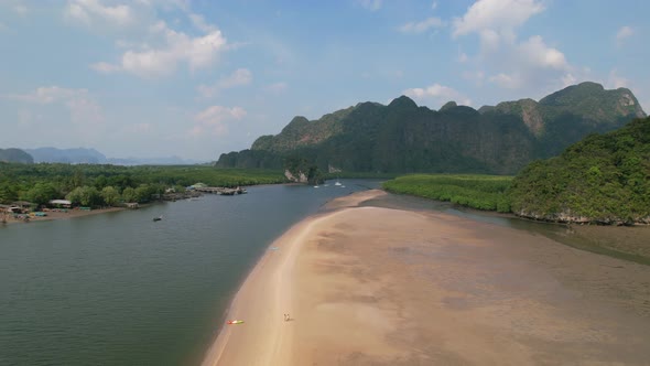 drone revealing a kayak on a sandbar surrounded by a river and mangroves on a sunny day in Ao Thalan