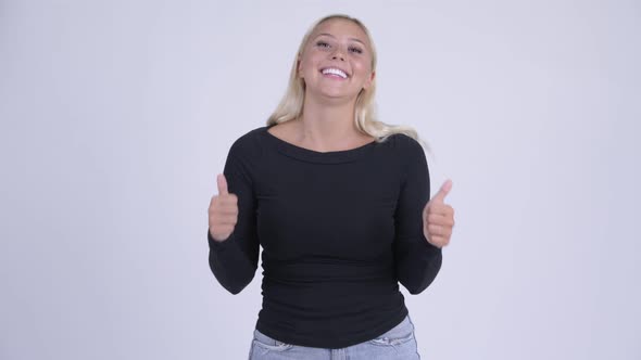 Young Happy Blonde Woman Looking Excited While Giving Thumbs Up