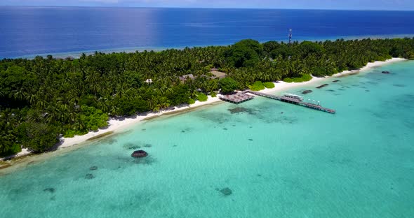 Natural fly over island view of a white sand paradise beach and turquoise sea background in colorful