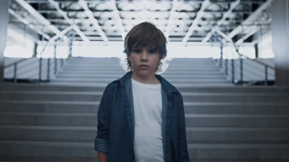 Depressed School Boy Standing Alone at Empty Staircase Close Up