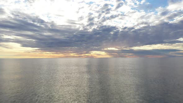 AERIAL: Flying Backwards During Golden Hour with Majestic Horizon 