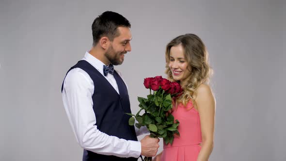 Happy Man Giving Flowers To Woman