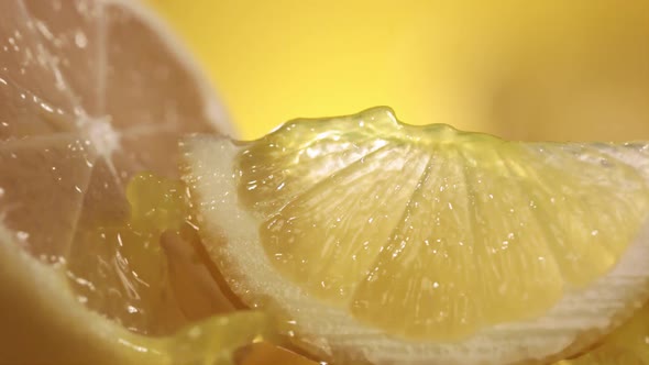 Slow Motion Shot of Lemon Juice Splashing Through Lemon Slices