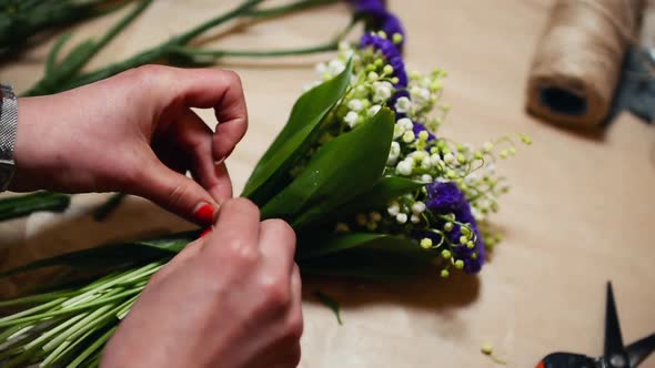 Florist Tying Ribbons to Make a Bow. Fresh Modern Bouquet