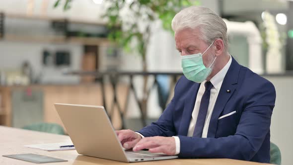 Senior Old Businessman with Face Mask Working on Laptop 