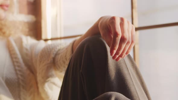 Close Up of a Hand in a Bright Sunlight By the Window in a Loft Apartment