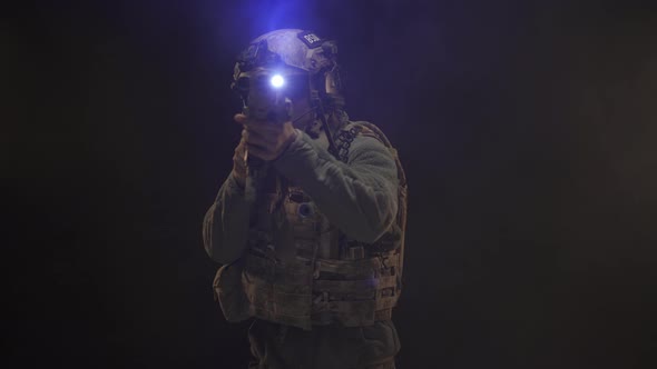 US Special Forces Soldier Aiming with Rifle at Night in Darkness